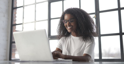 woman in white crew neck t shirt sitting by the window