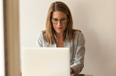 woman sitting while using laptop